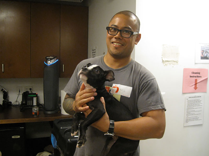 a man holding a small dog