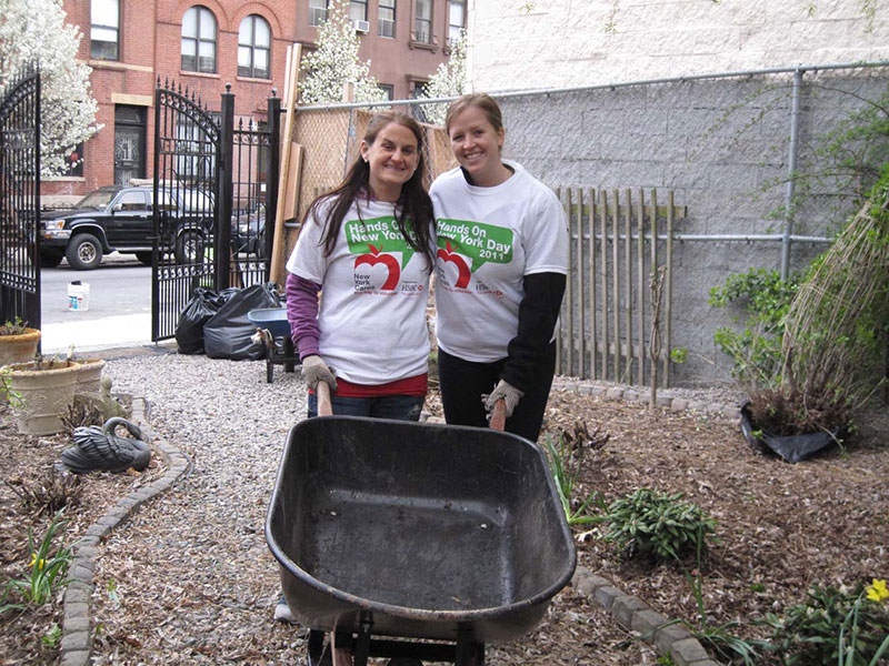 two people using a wheel barrow